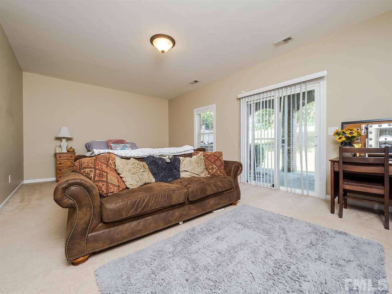 3005 Imperial Oaks Drive Raleigh, NC 27614 - Photo 19 of 25 a spacious bedroom with a bed and a couch