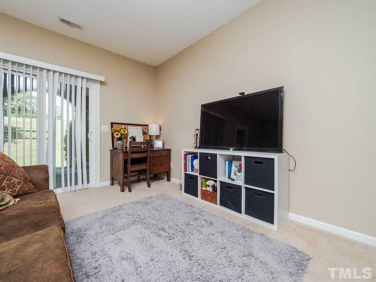 3005 Imperial Oaks Drive Raleigh, NC 27614 - Photo 20 of 25 a living room with furniture and a flat screen tv