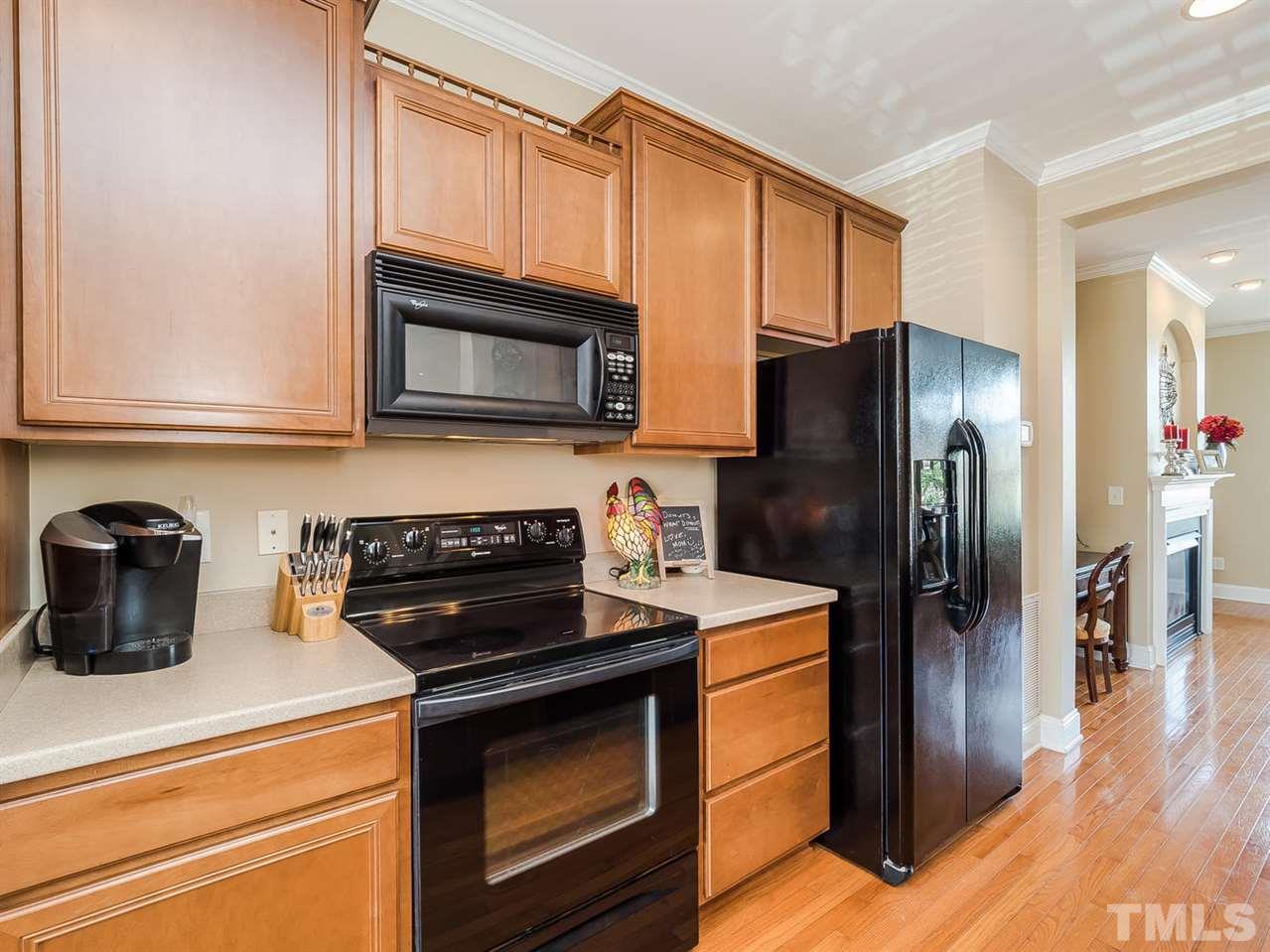 3005 Imperial Oaks Drive Raleigh, NC 27614 - Photo 6 of 25 a kitchen with stainless steel appliances granite countertop a stove microwave refrigerator and sink