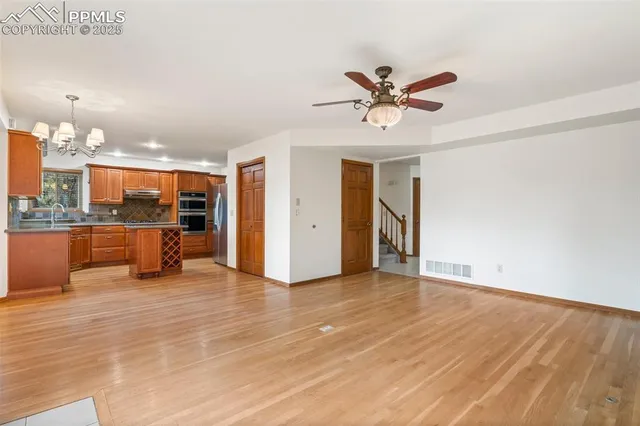 a view of an empty room with a kitchen