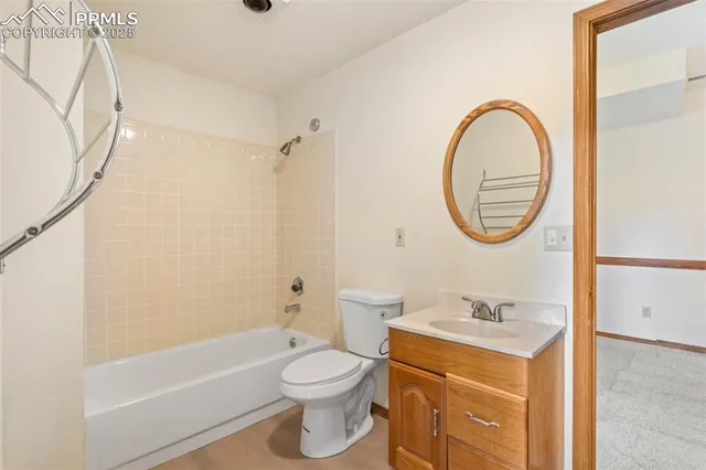 a bathroom with a sink a mirror a toilet and a bathtub