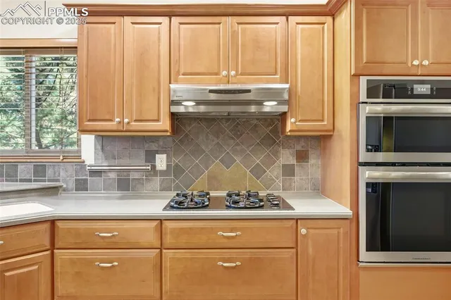 a kitchen with granite countertop cabinets stainless steel appliances and a sink