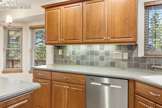 a kitchen with granite countertop cabinets stainless steel appliances and a sink