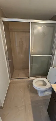 a spacious bathroom with a double vanity sink and a mirror