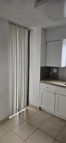 a view of a utility room with cabinets