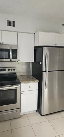 a kitchen with a stove microwave and refrigerator