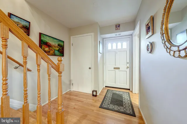 a view of an entryway with wooden floor and door