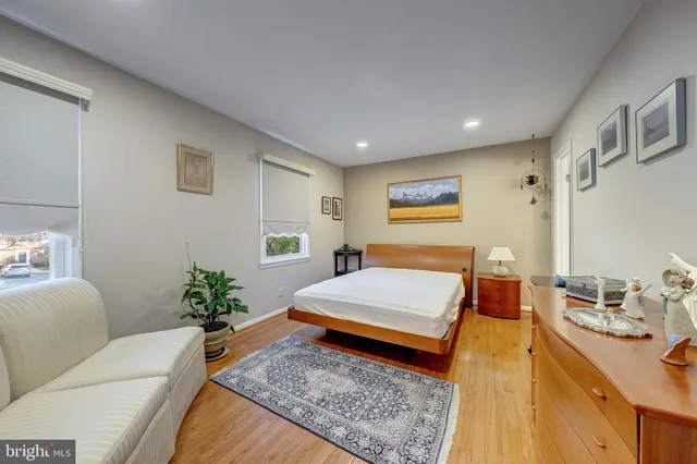 a living room with furniture and paintings