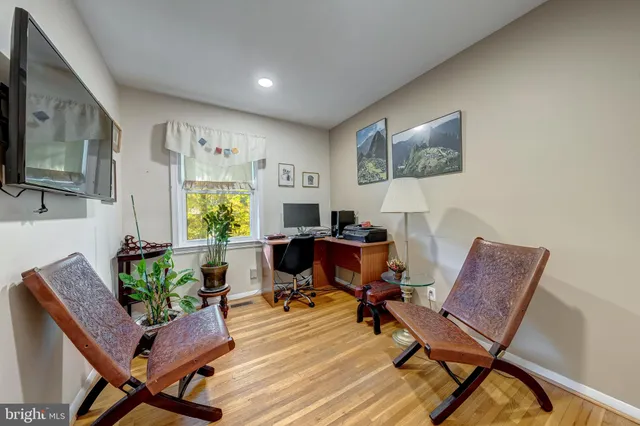 a workspace with lounge chair and a window