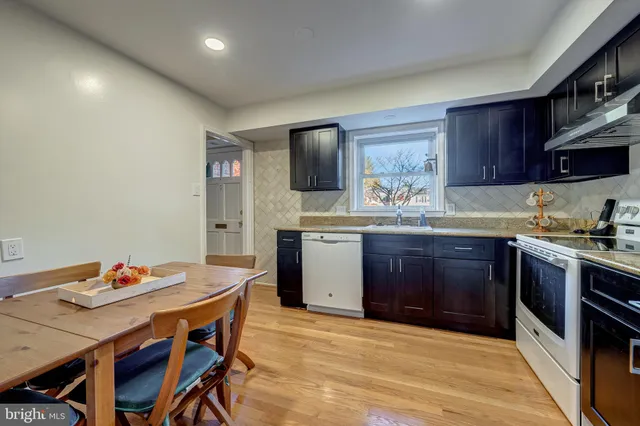 a kitchen with stainless steel appliances granite countertop a stove a sink dishwasher and cabinets