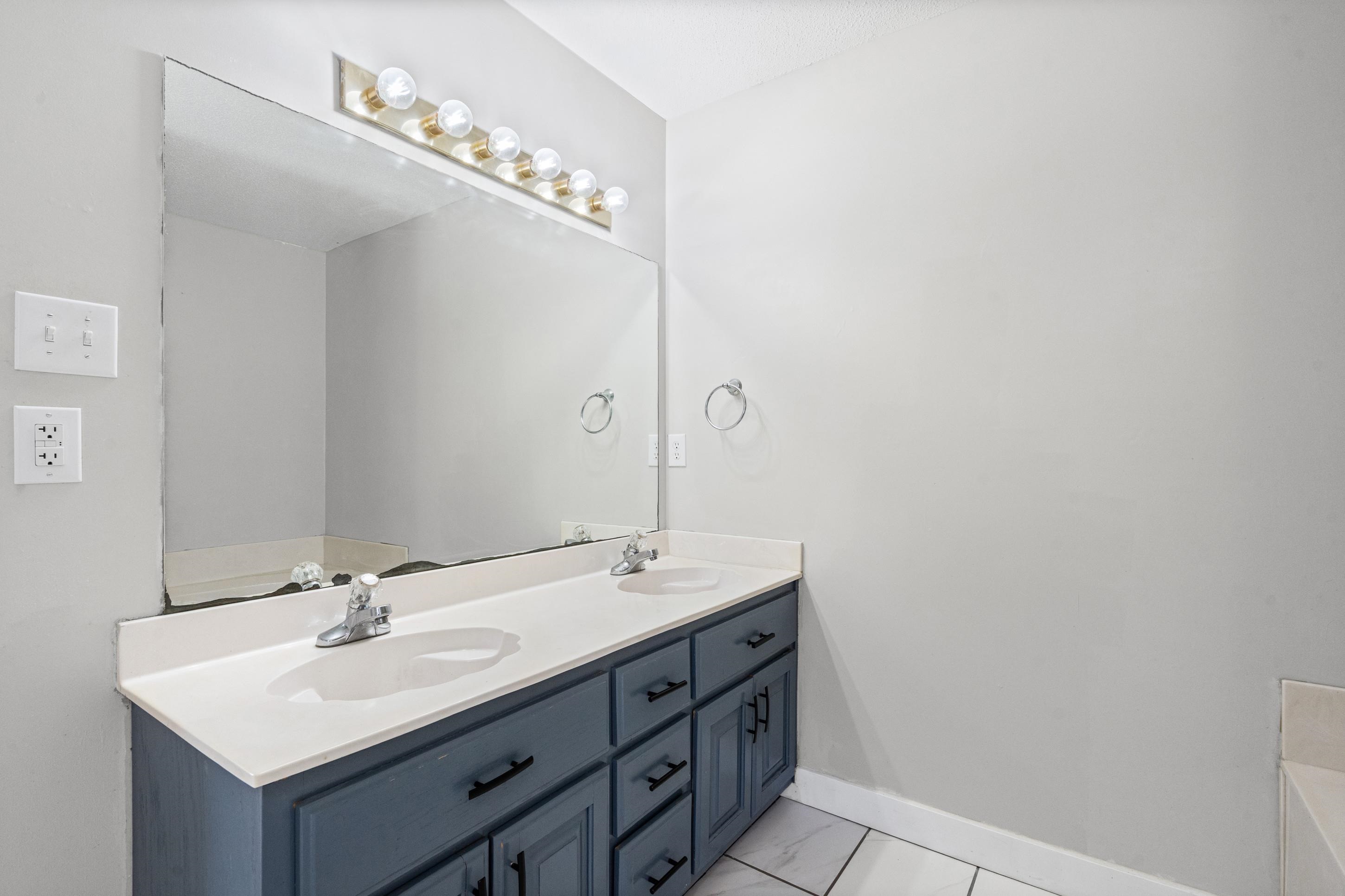 511 Rae Drive Munford, TN 38058 - Photo 13 of 30 Bathroom featuring double vanity, light marble finish flooring, and a bathtub