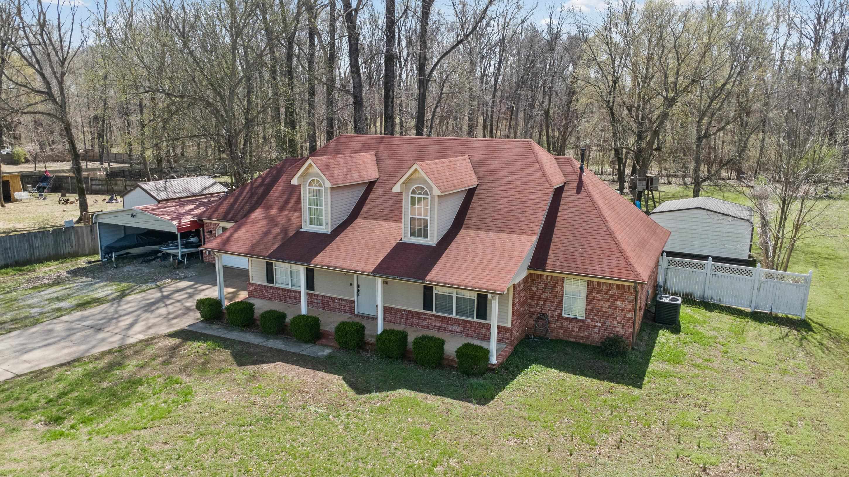 511 Rae Drive Munford, TN 38058 - Photo 25 of 30 View of front facade featuring a porch, brick siding, roof with shingles, and concrete driveway