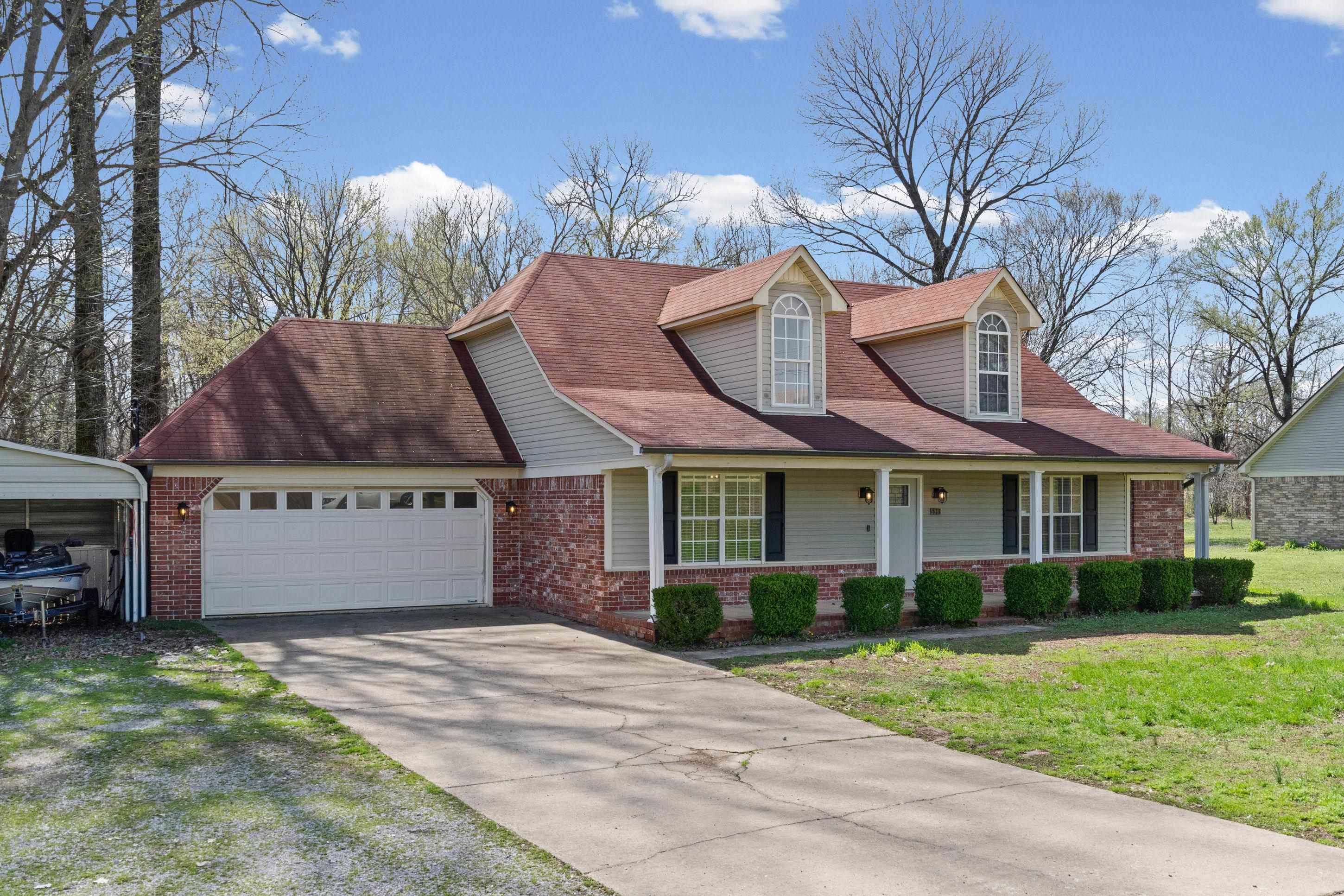 511 Rae Drive Munford, TN 38058 - Photo 3 of 30 Cape cod-style house featuring concrete driveway, a garage, a porch, and brick siding