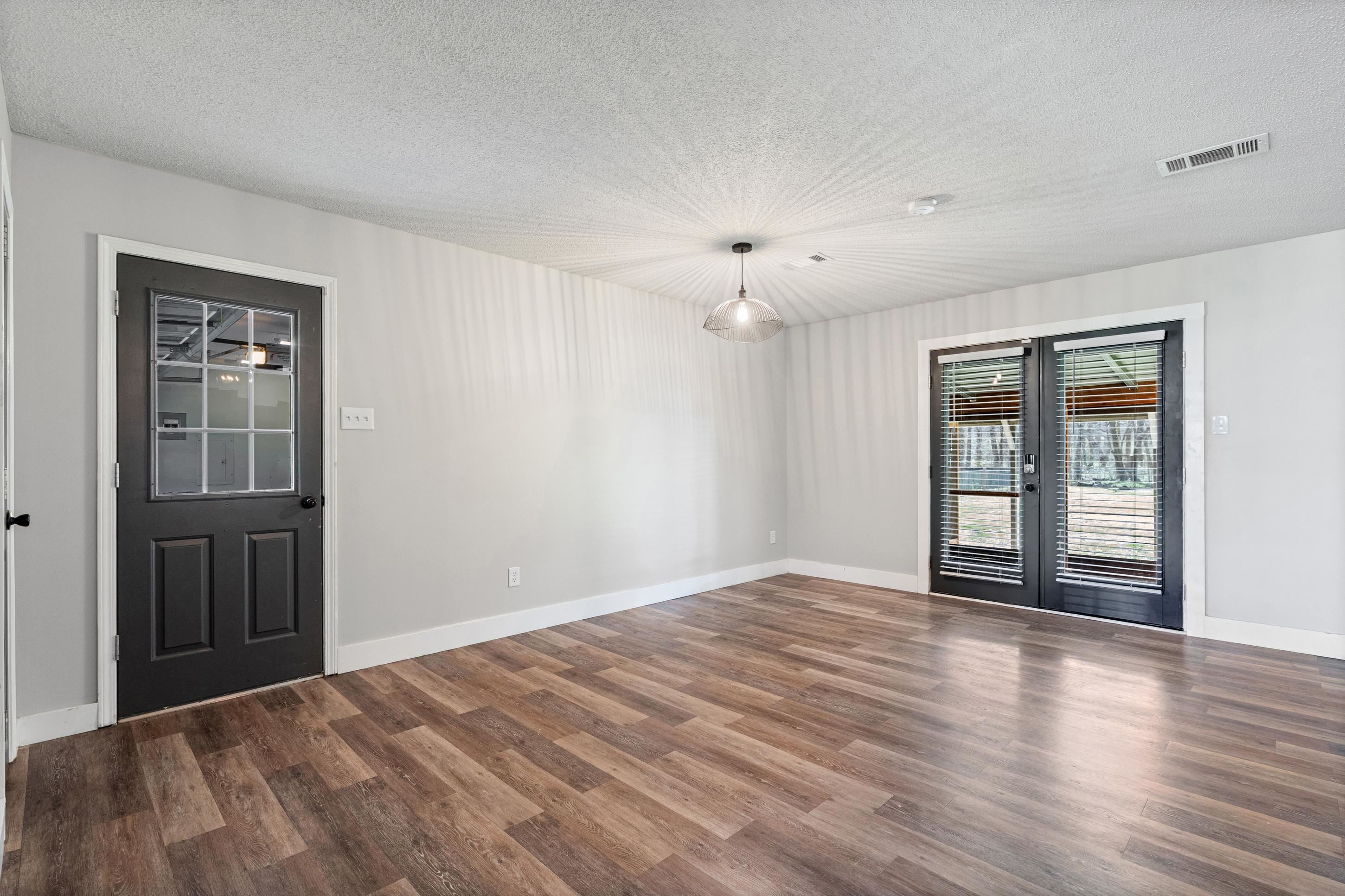 511 Rae Drive Munford, TN 38058 - Photo 8 of 30 Breaksfast area featuring a textured ceiling, french doors, and dark wood finished floors