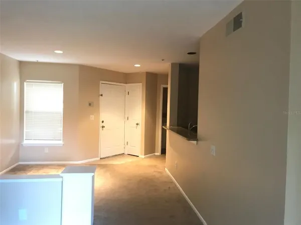 a view of an empty room with a window