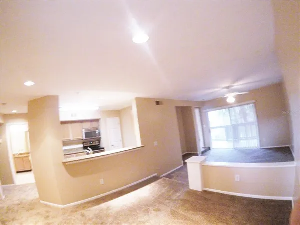 a kitchen with kitchen island sink and refrigerator