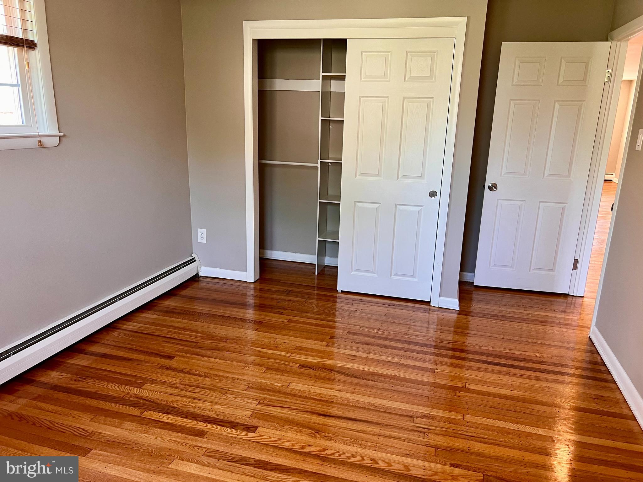 7804 Winston Road, Unit 1 Philadelphia, PA 19118 - Photo 13 of 13 an empty room with wooden floor and entrance