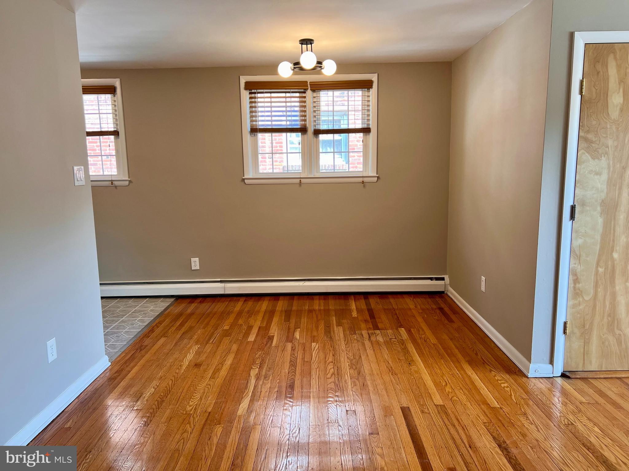 7804 Winston Road, Unit 1 Philadelphia, PA 19118 - Photo 8 of 13 a view of a room with wooden floor and chandelier