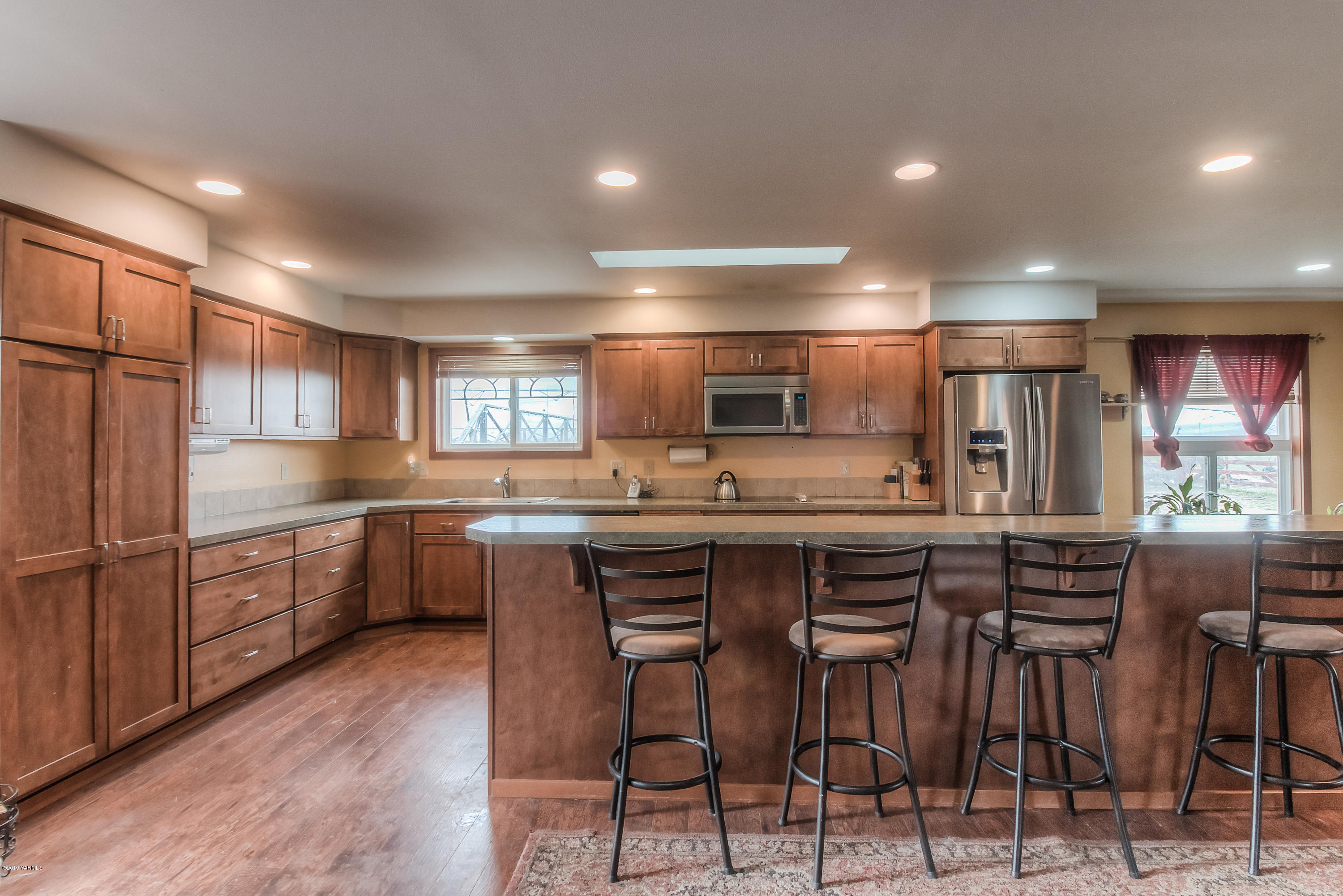 111 Beam Road Granger, WA 98932 - Photo 2 of 27 a kitchen with stainless steel appliances kitchen island granite countertop a table chairs sink and cabinets