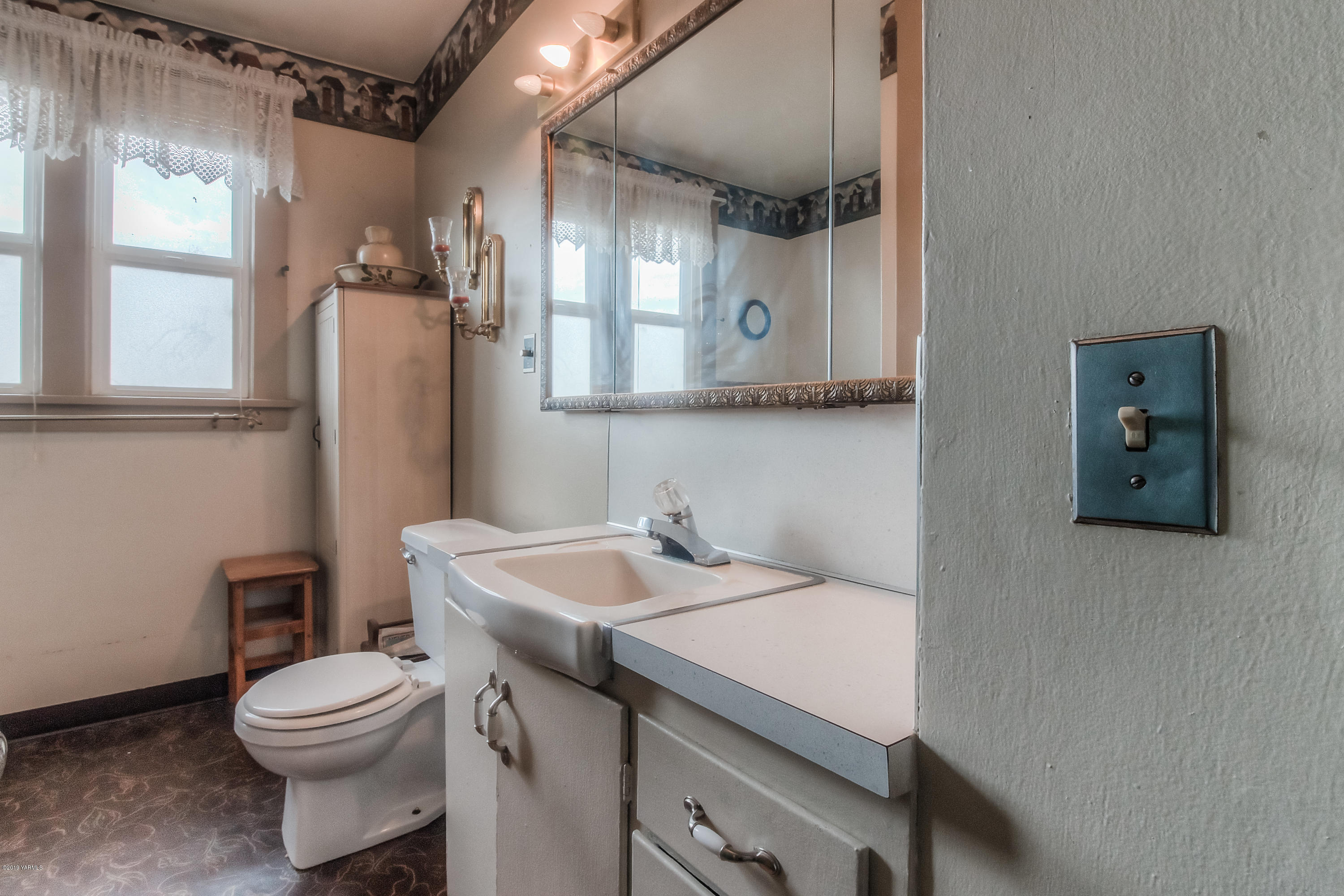 111 Beam Road Granger, WA 98932 - Photo 14 of 27 a bathroom with a sink a toilet and mirror
