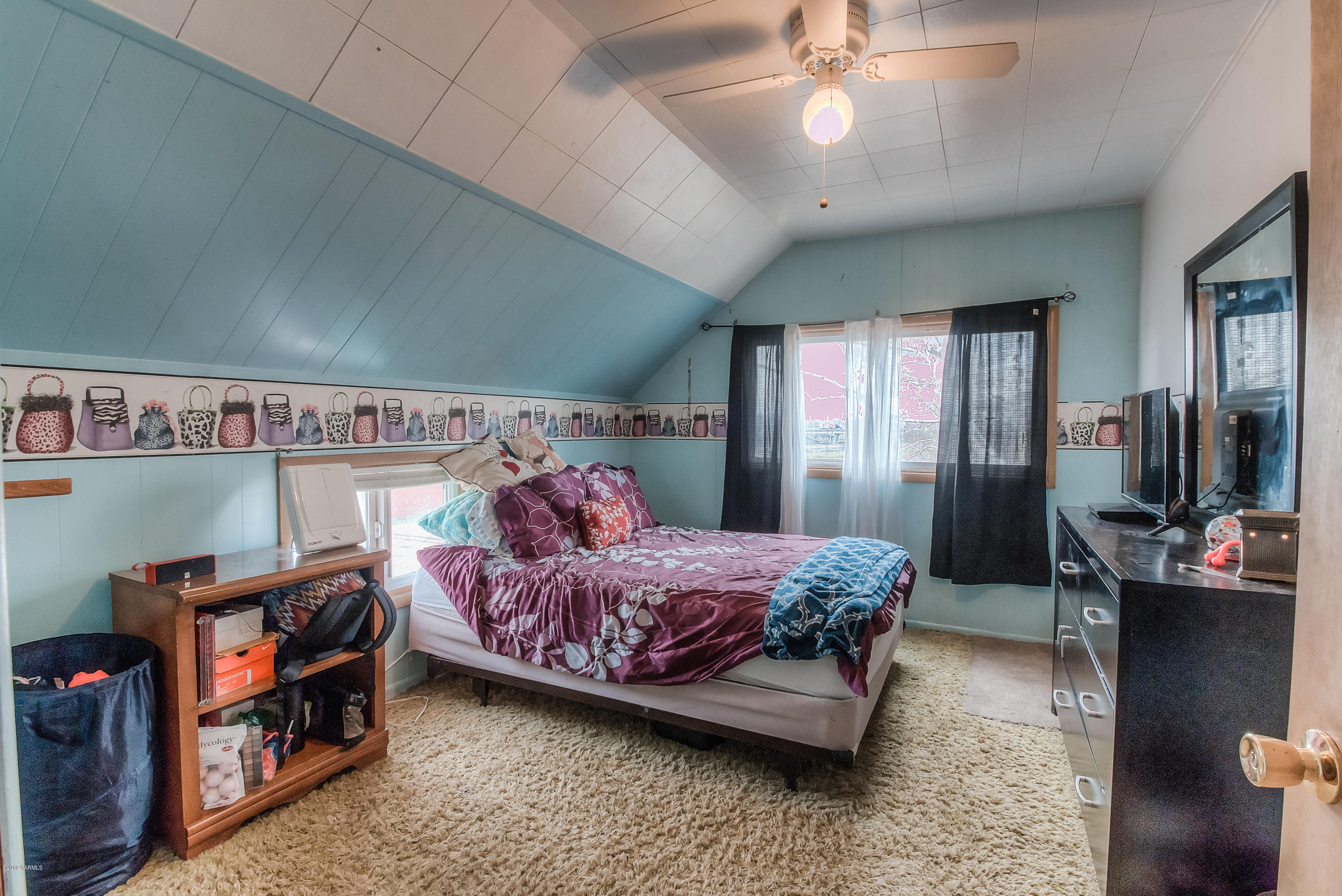 111 Beam Road Granger, WA 98932 - Photo 17 of 27 a bedroom with a bed bookshelf and a walk in closet