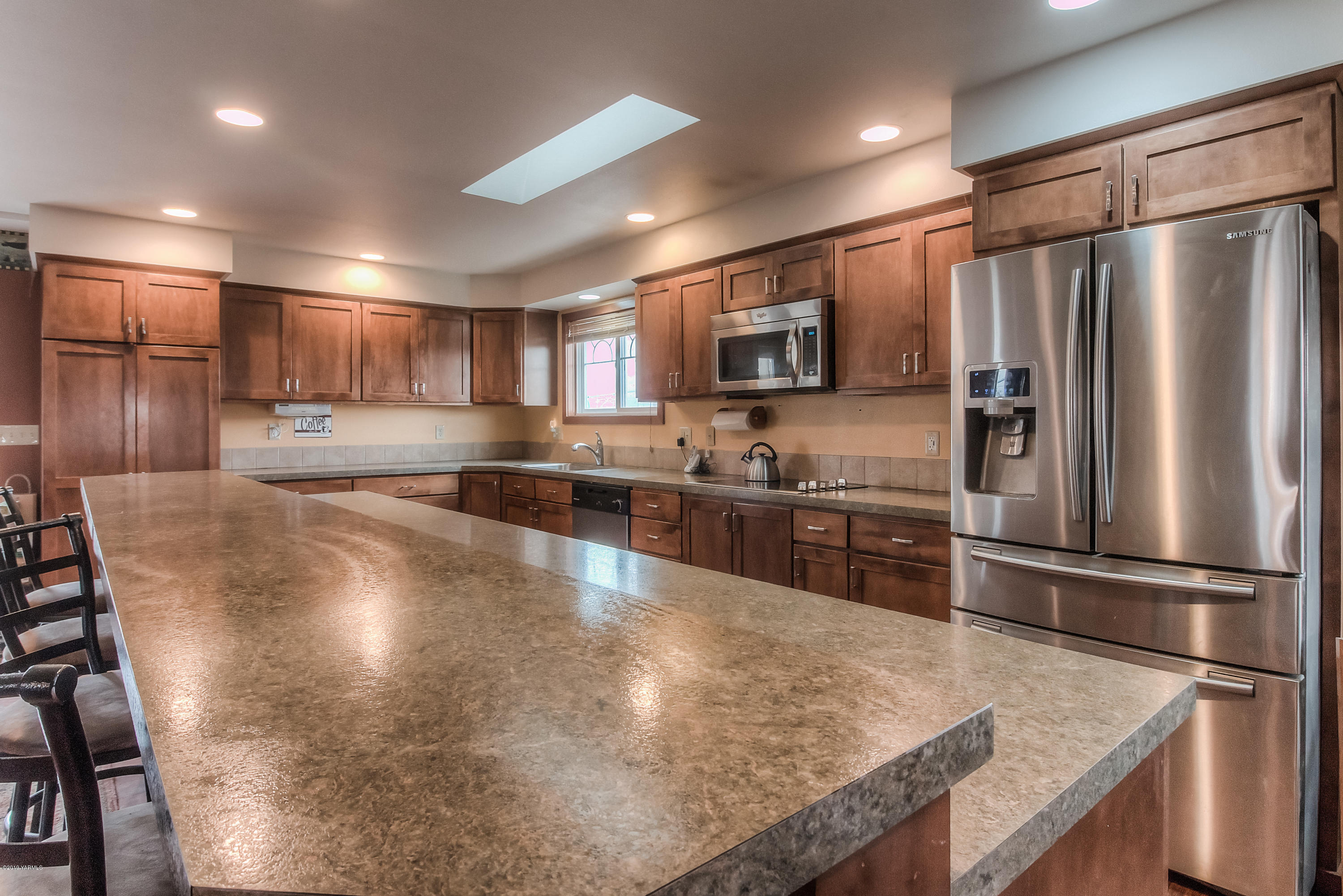 111 Beam Road Granger, WA 98932 - Photo 4 of 27 a kitchen with kitchen island a counter top space stainless steel appliances and cabinets