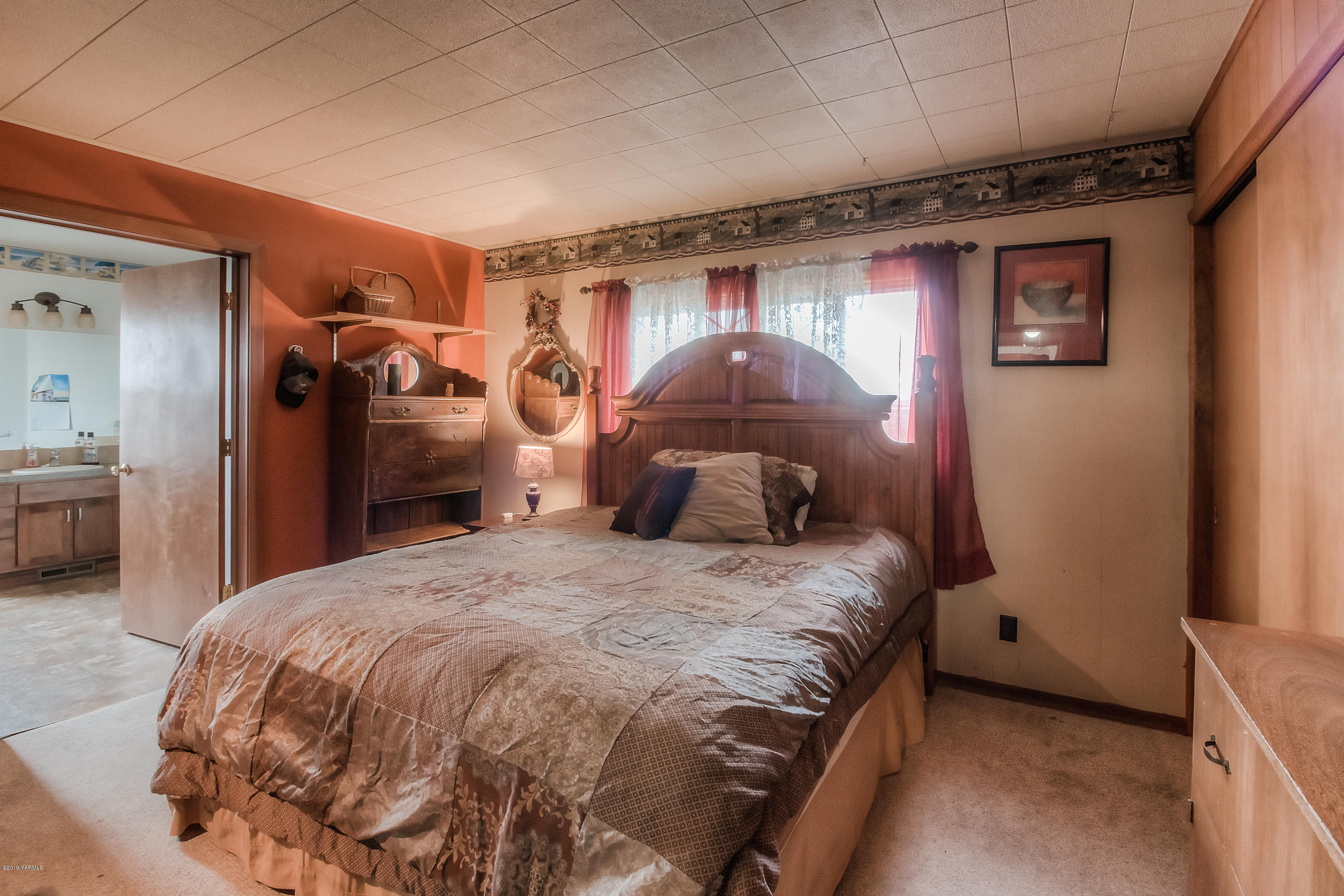 111 Beam Road Granger, WA 98932 - Photo 8 of 27 a bedroom with a bed and a mirror