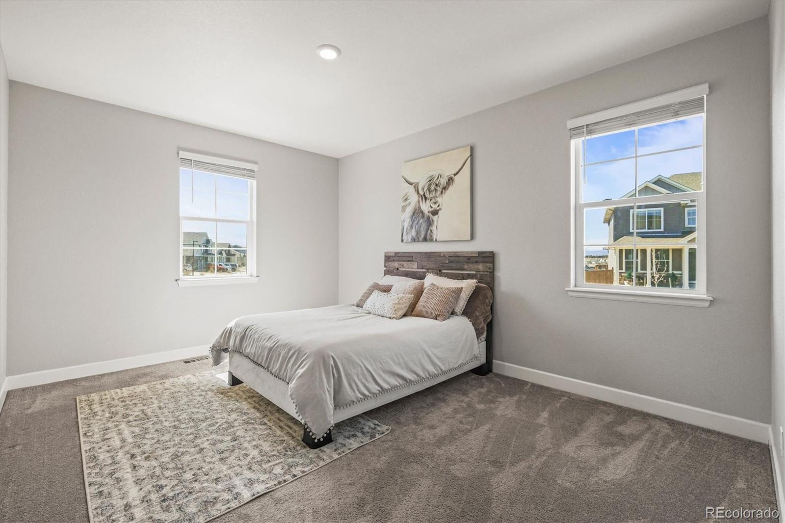 1624 Pinion Wing Circle Castle Rock, CO 80108 - Photo 15 of 47 a spacious bedroom with a bed and a window