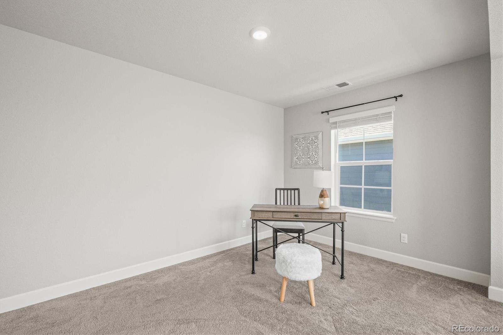 1624 Pinion Wing Circle Castle Rock, CO 80108 - Photo 24 of 47 a view of a room with chairs and table in a room