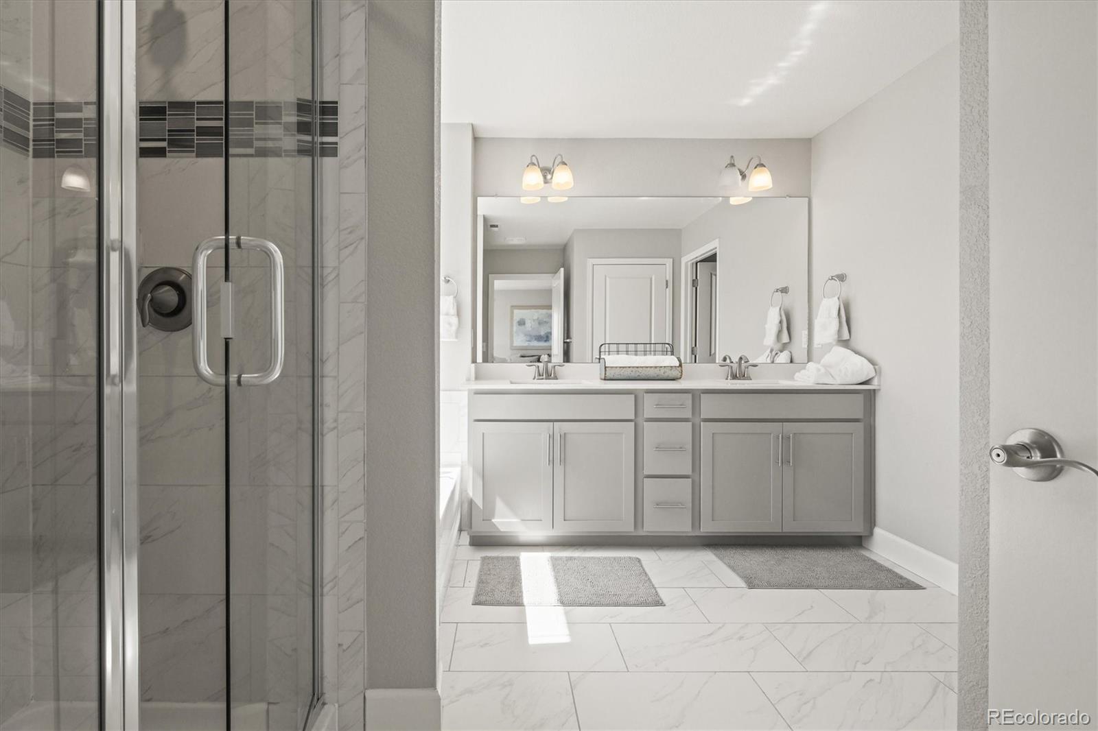 1624 Pinion Wing Circle Castle Rock, CO 80108 - Photo 26 of 47 a bathroom with a sink a mirror and shower