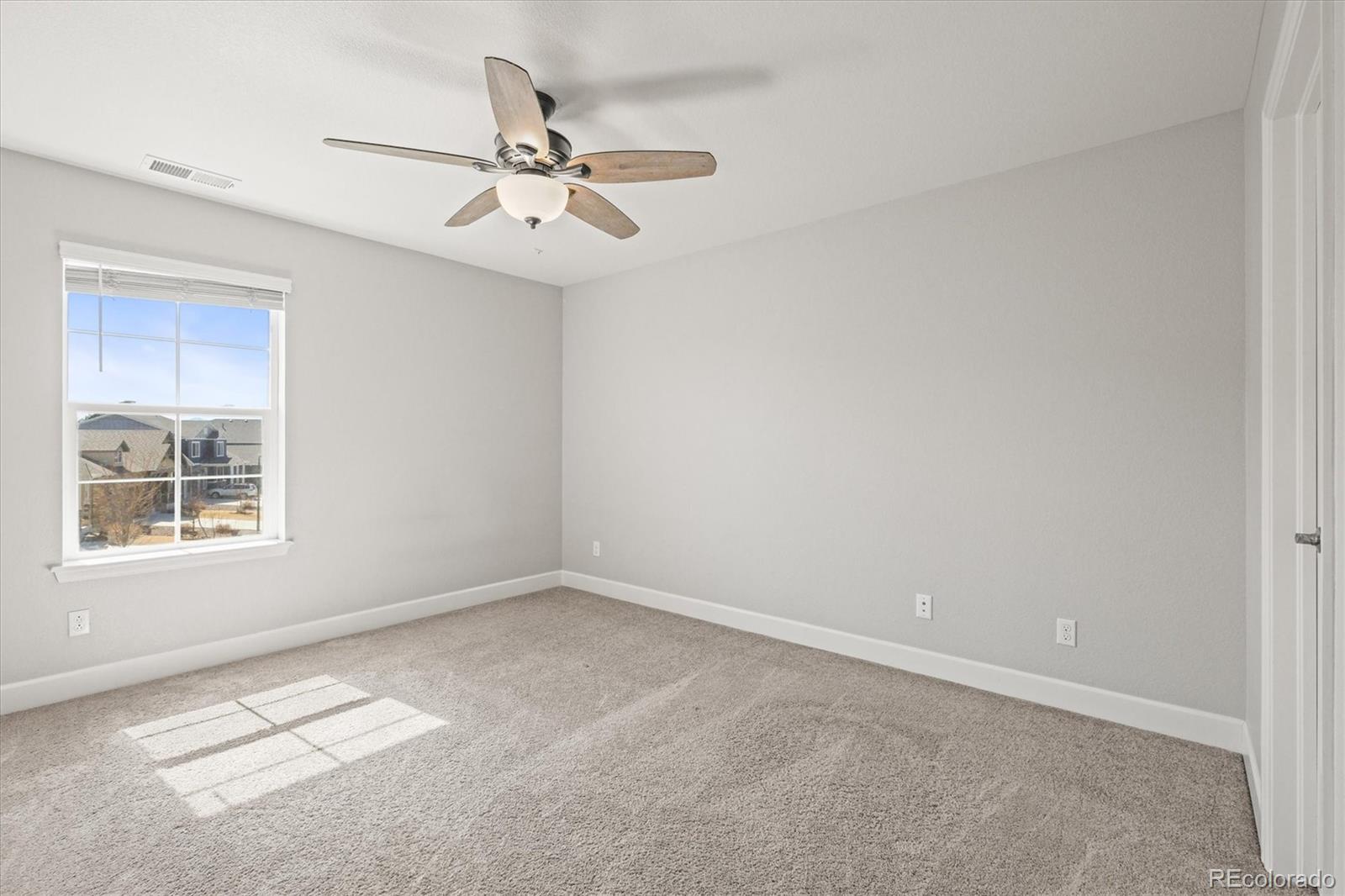 1624 Pinion Wing Circle Castle Rock, CO 80108 - Photo 36 of 47 an empty room with a window and a fan