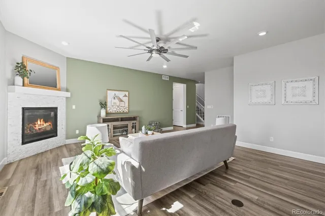 a large kitchen with stainless steel appliances kitchen island a large counter top a stove a refrigerator cabinets and living room view