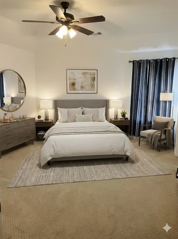 a bedroom with a large bed and a chandelier