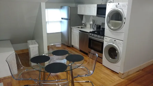 a kitchen with a sink a stove and a microwave