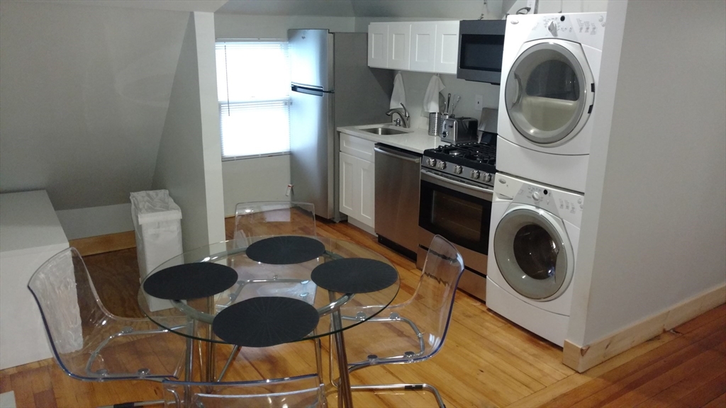 12 Bennett Street, Unit 3 Boston, MA 02135 - Photo 1 of 17 a kitchen with a sink a stove and a microwave
