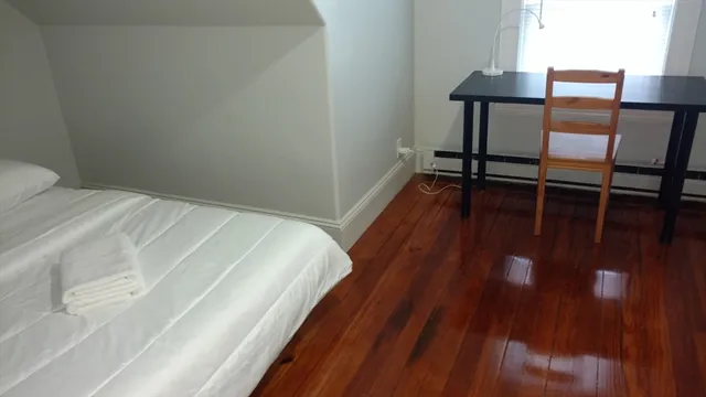 a bedroom with a bed and a table in it