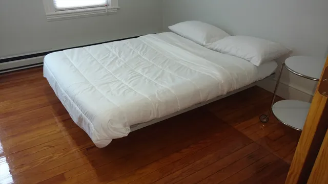 a bed sitting in a bedroom next to a window