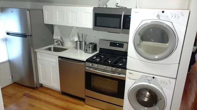 a kitchen with stove top oven and cabinets