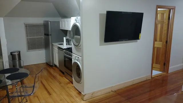 a view of a livingroom with furniture and a flat screen tv