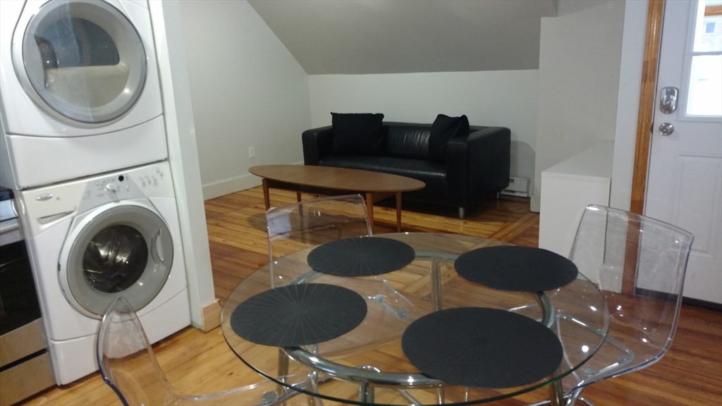 12 Bennett Street, Unit 3 Boston, MA 02135 - Photo 7 of 17 a living room with furniture and a fireplace