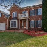 front view of a brick house with a yard