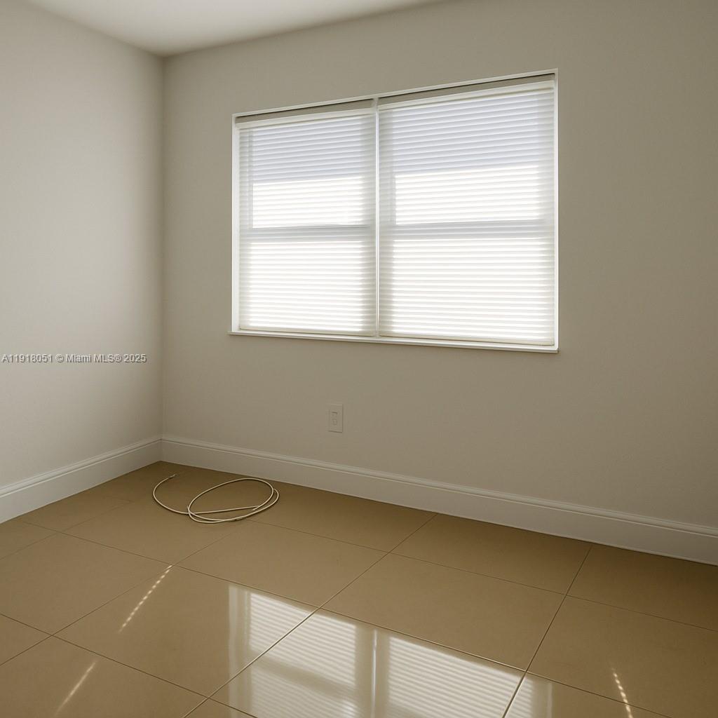 724 Northwest 3rd Court, Unit 2 Hallandale Beach, FL 33009 - Photo 6 of 6 an empty room with a window