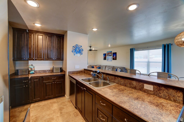 3853 South Red Valley Circle, Unit 22A1 Moab, UT 84532 - Photo 3 of 28 Kitchen with dark wood finish cabinets, ceiling fan, recessed lighting, a peninsula, and stainless steel dishwasher
