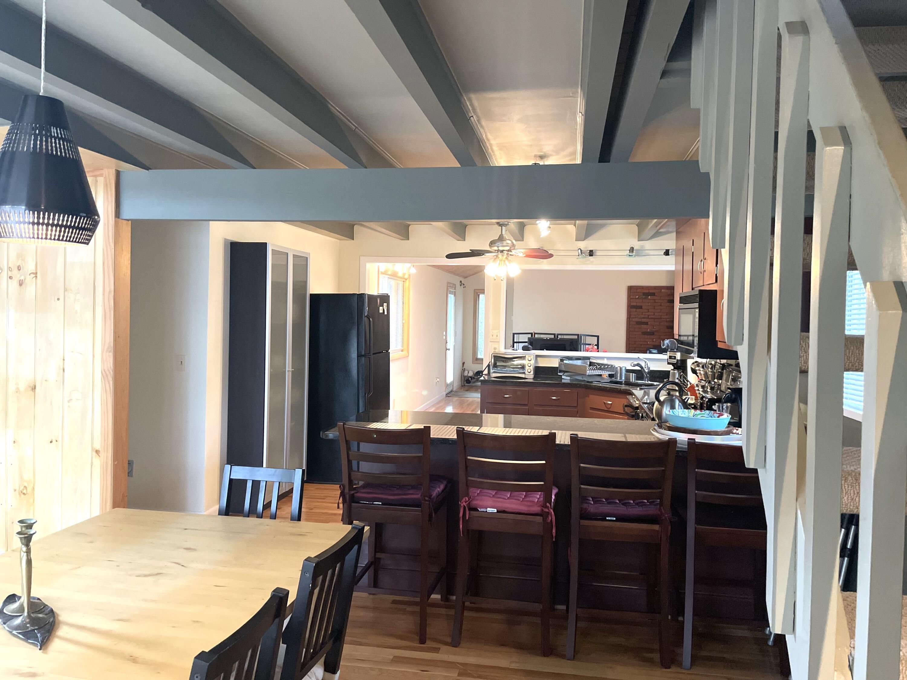 1 Summersea Road Mashpee, MA 02649 - Photo 12 of 34 a kitchen with a table chairs and a refrigerator