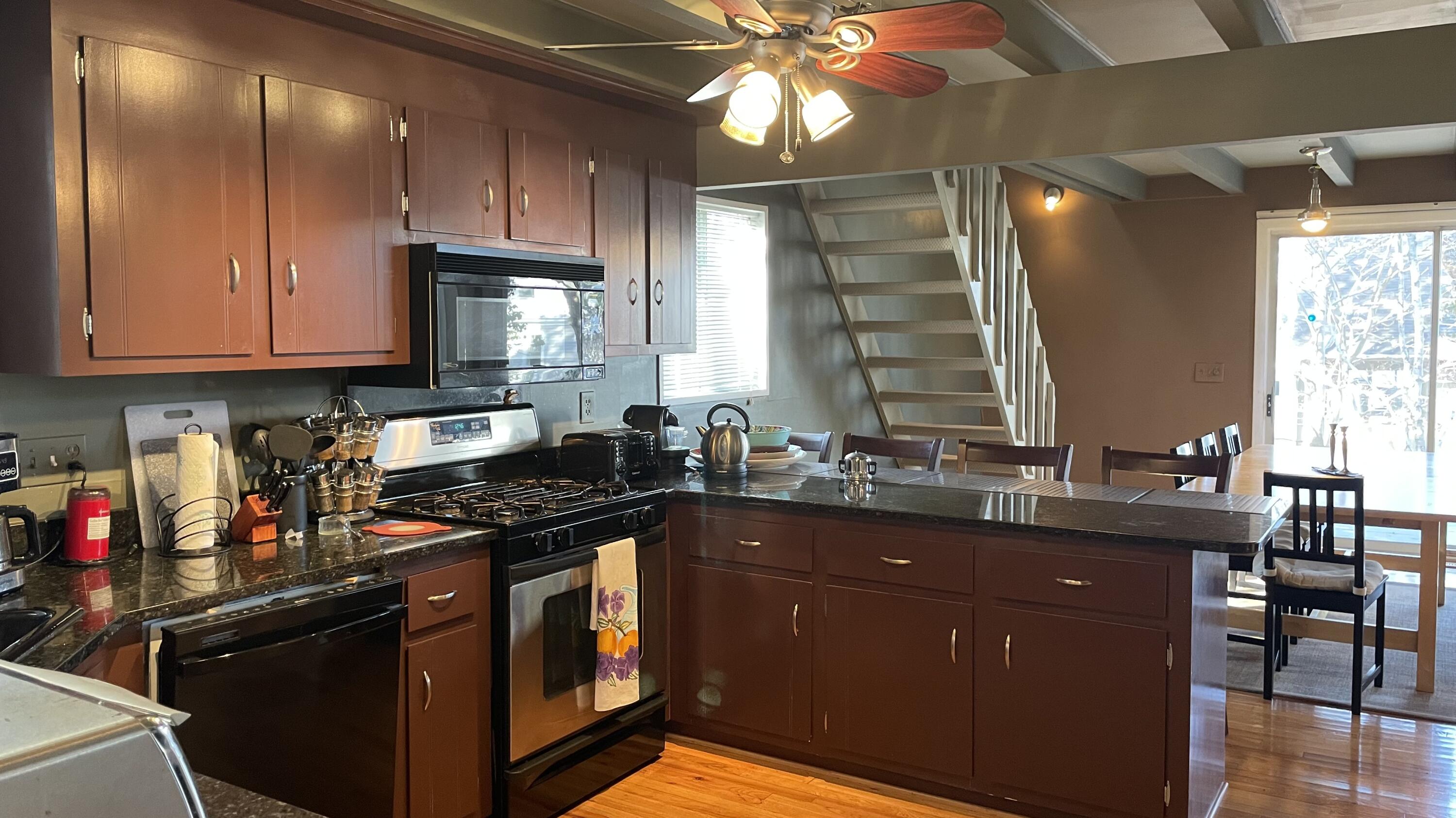 1 Summersea Road Mashpee, MA 02649 - Photo 14 of 34 a kitchen with granite countertop a sink stainless steel appliances cabinets and a counter space