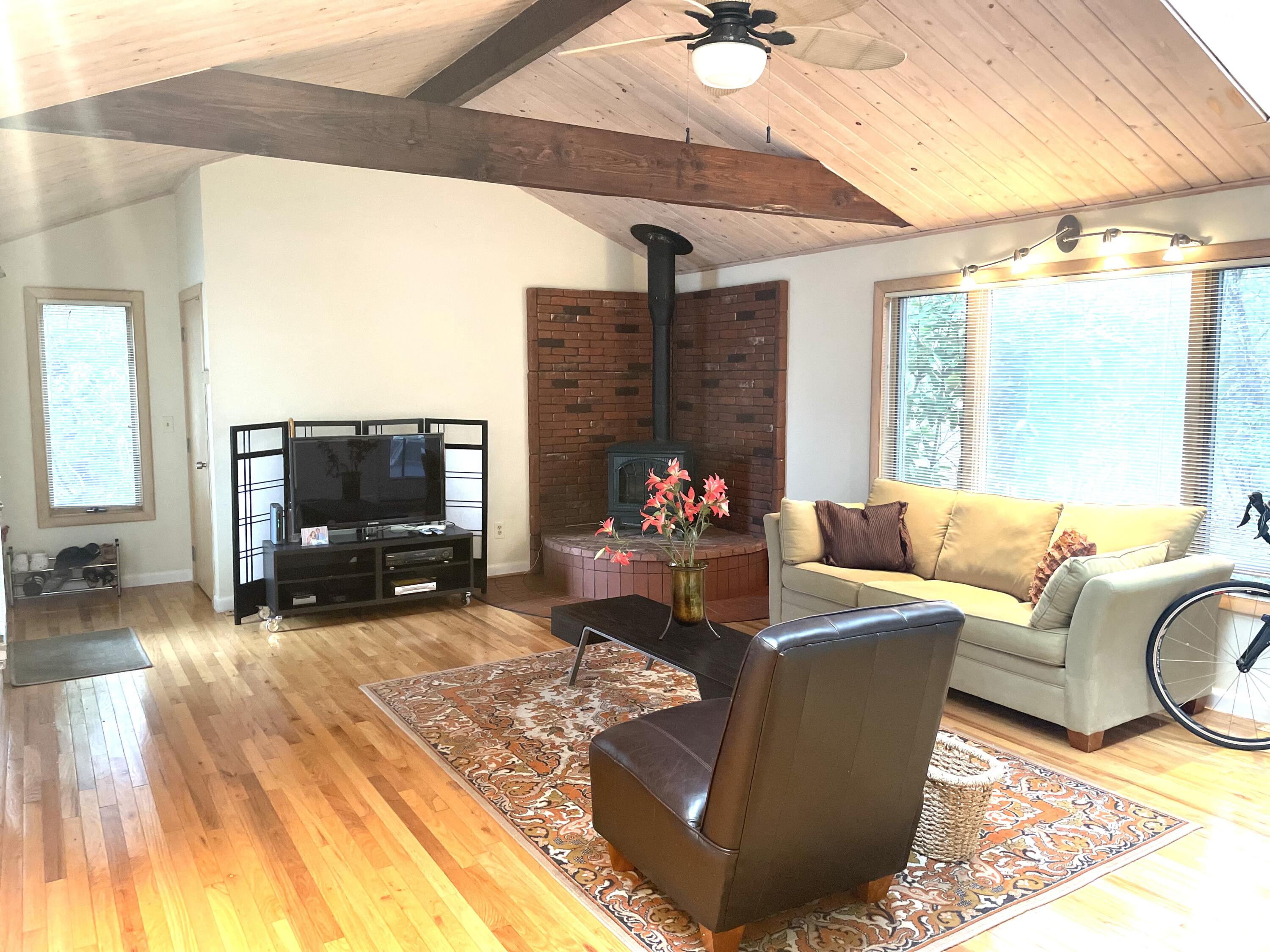 1 Summersea Road Mashpee, MA 02649 - Photo 18 of 34 a living room with furniture a flat screen tv and a fireplace