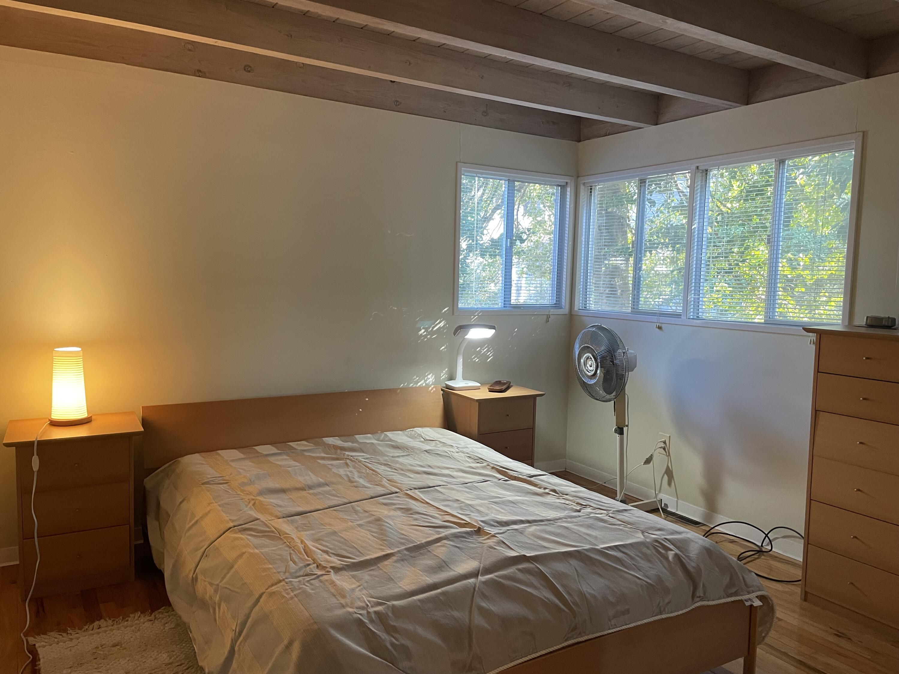 1 Summersea Road Mashpee, MA 02649 - Photo 20 of 34 a bedroom with a bed and a lamp next to a window