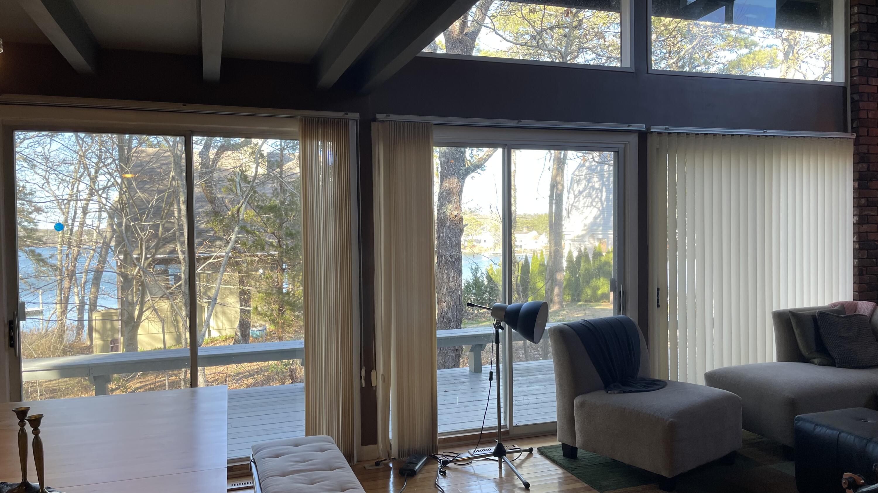 1 Summersea Road Mashpee, MA 02649 - Photo 9 of 34 a living room with furniture and a floor to ceiling window