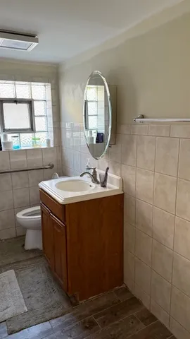 a bathroom with a sink mirror vanity and a toilet