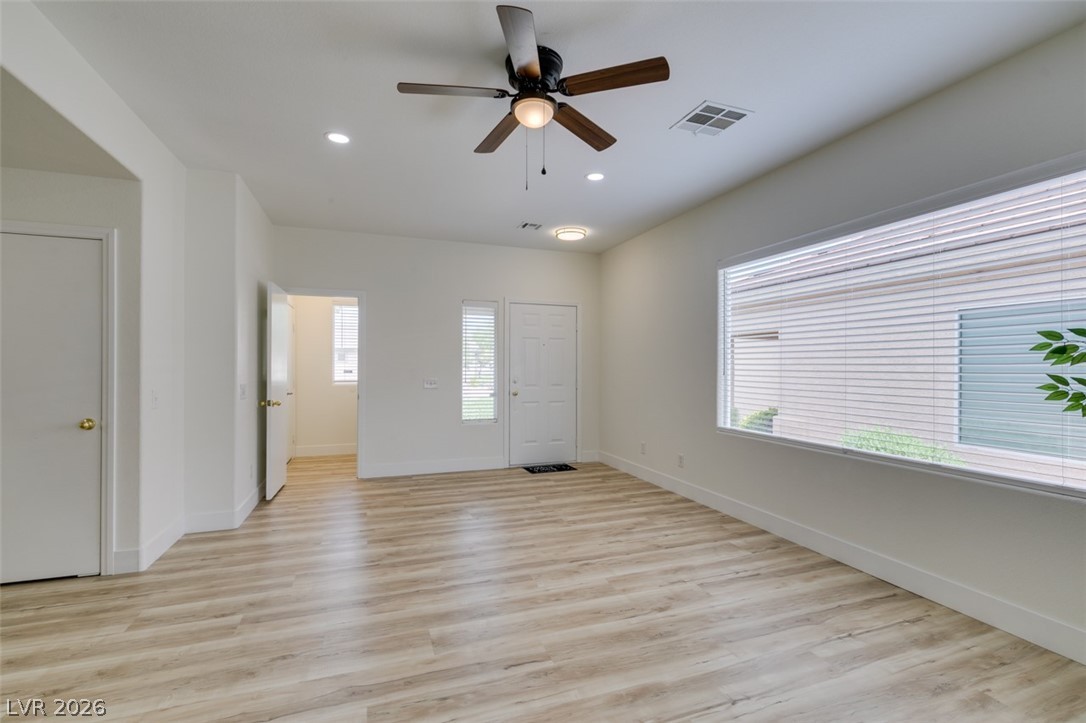 10959 Pumpkin Ridge Avenue Las Vegas, NV 89135 - Photo 4 of 51 Natural light and warm new flooring create a welcoming ambiance in this generous living space.
